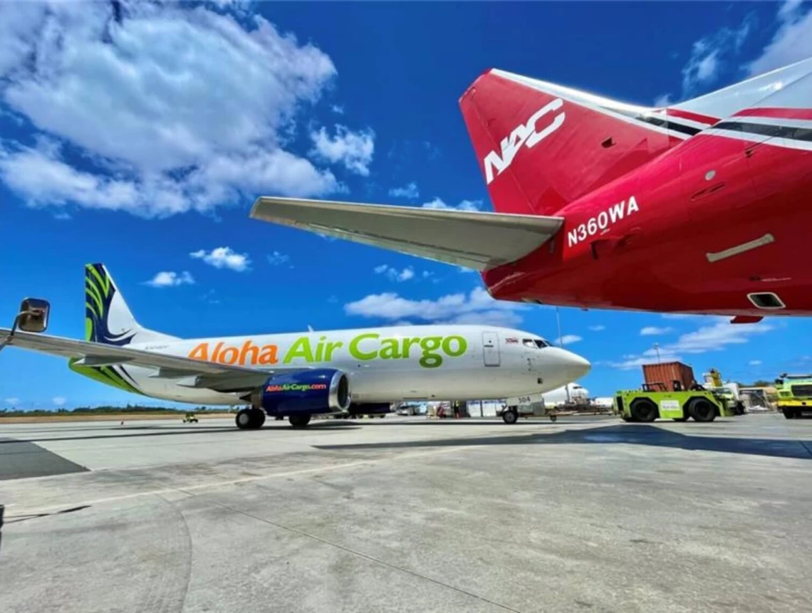 A photo of an Aloha Air Cargo and a Northern Air Cargo plane sitting side by side on the ramp.