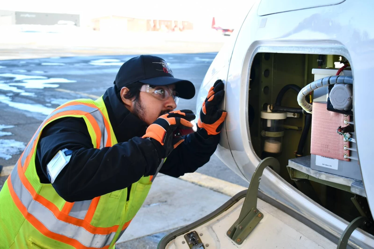 A NAMS employee inspecting a plane.