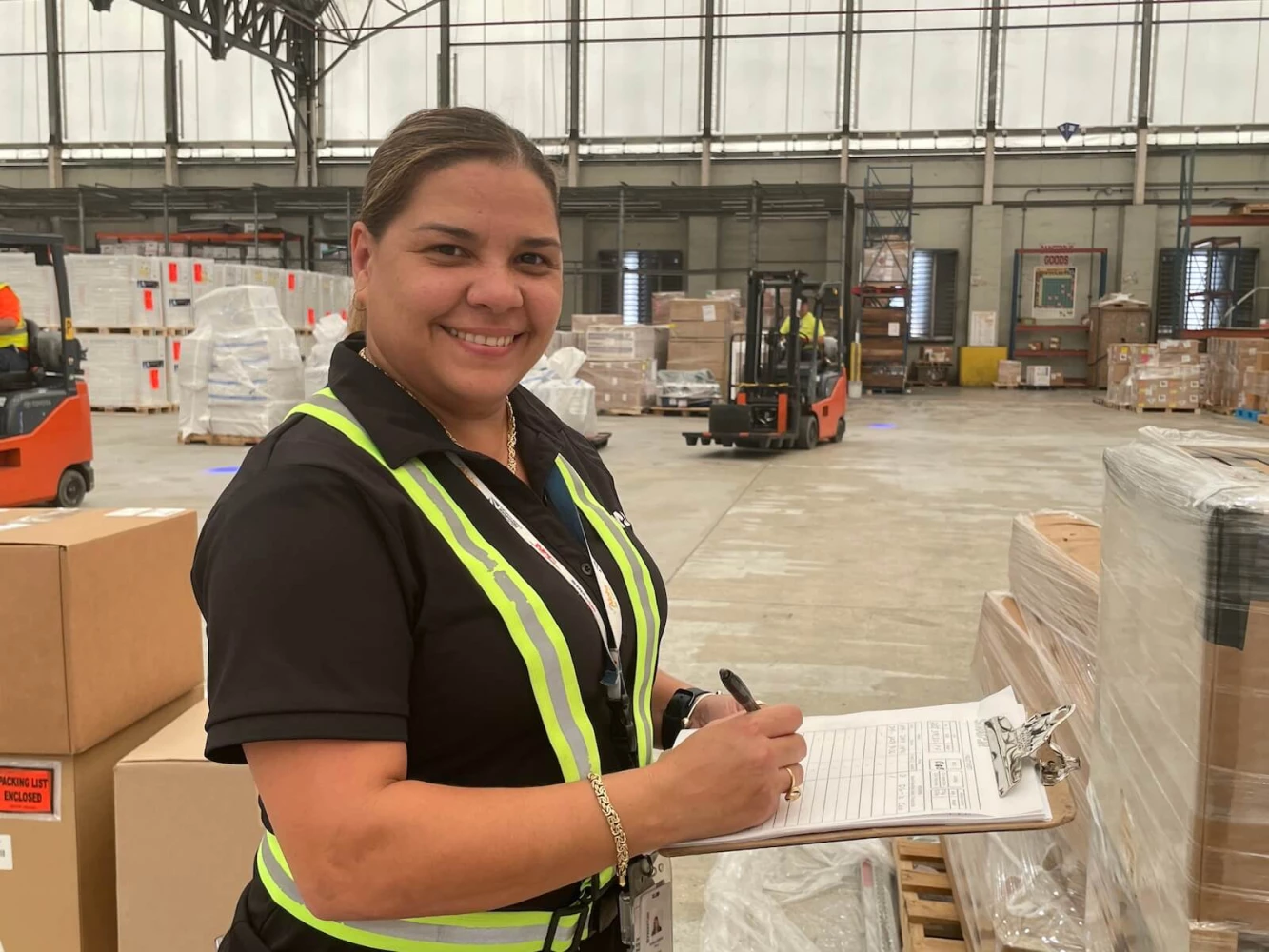 A StratAir employee holding a clipboard in the warehouse.