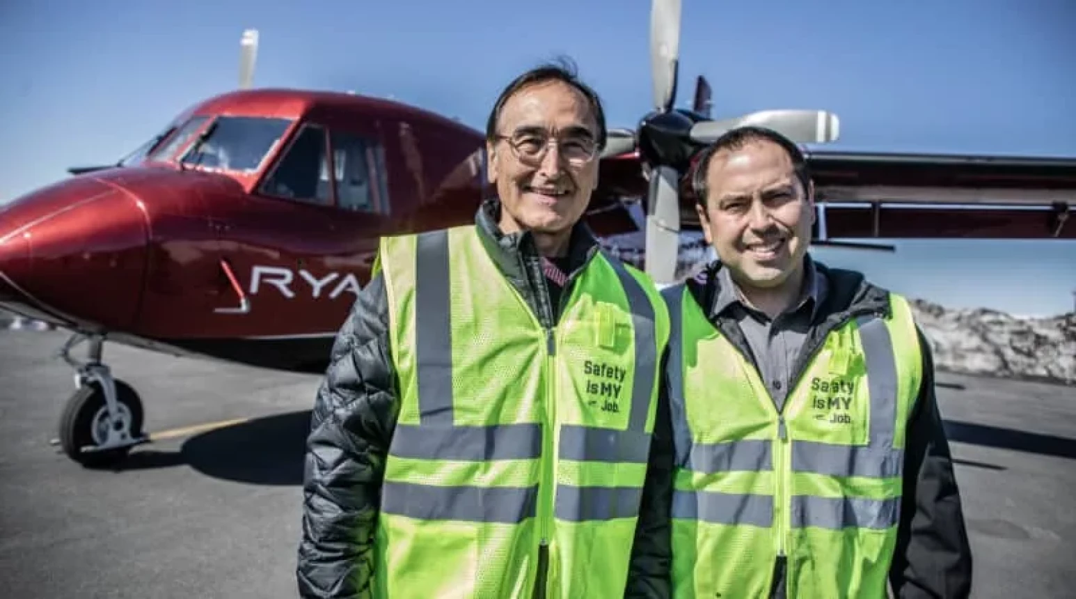 Photo of Lee and Wilfred Ryan standing in front of a Ryan Air plane.