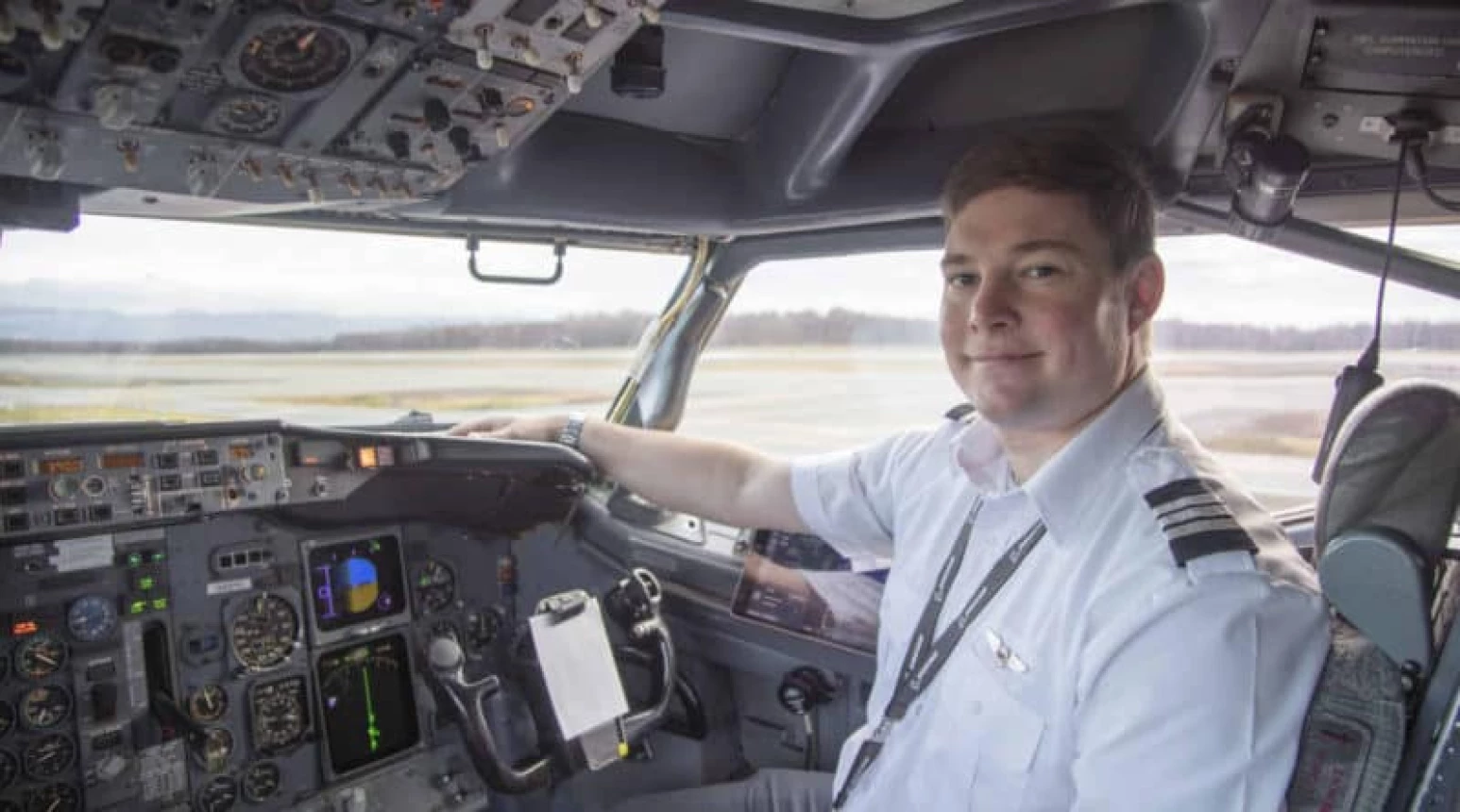 Photo of a NAC pilot sitting in the cockpit of a plane.