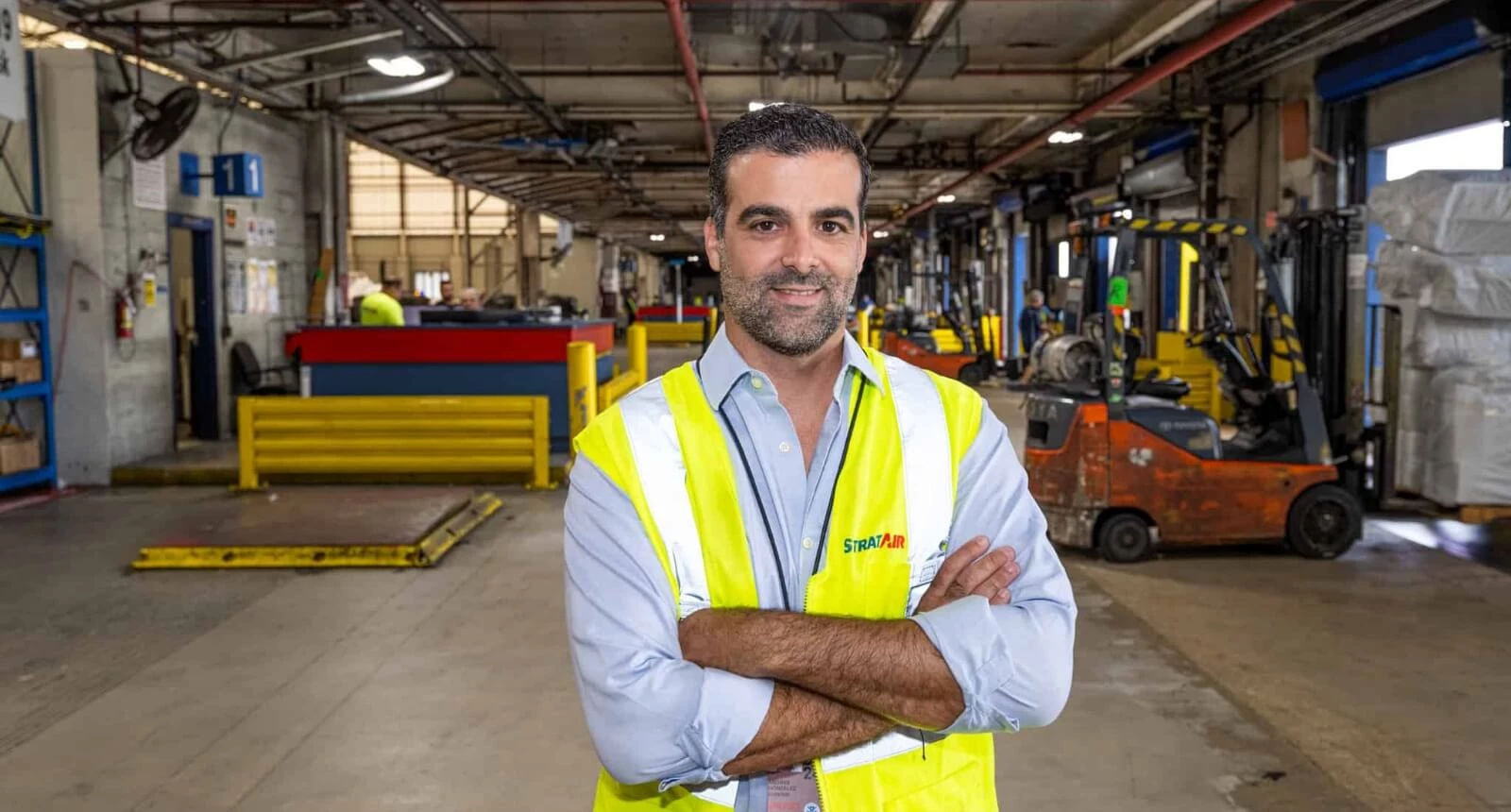 Photo of StratAir employee Andres Gonzales standing in the StratAir warehouse.